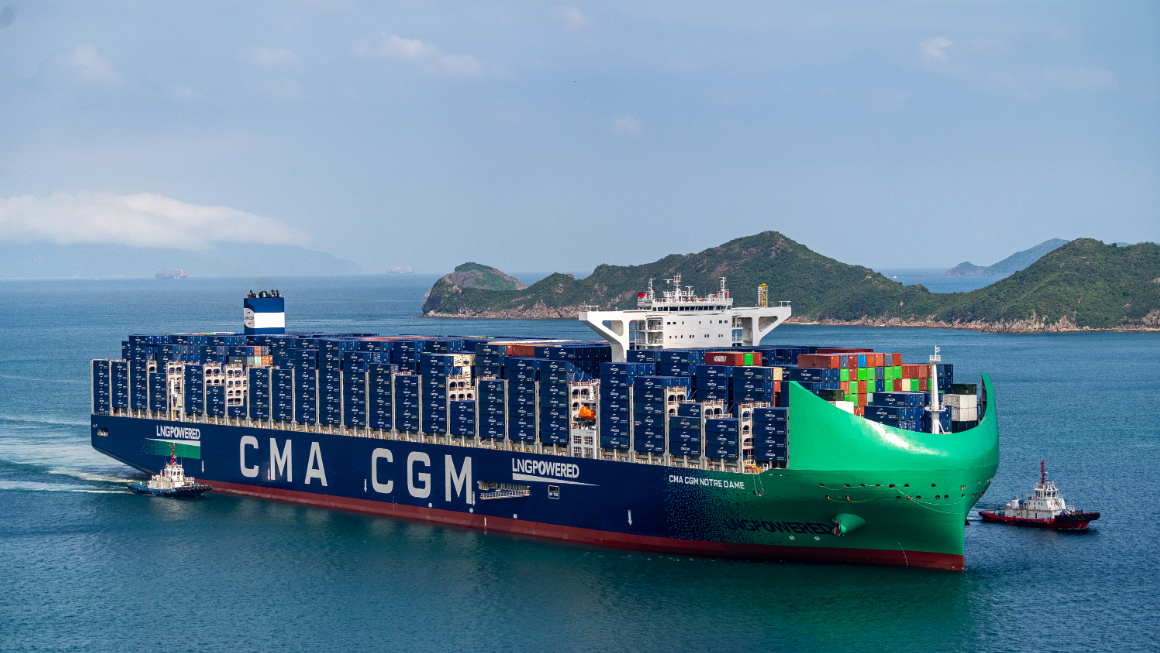 Container ship sailing near a coastline
